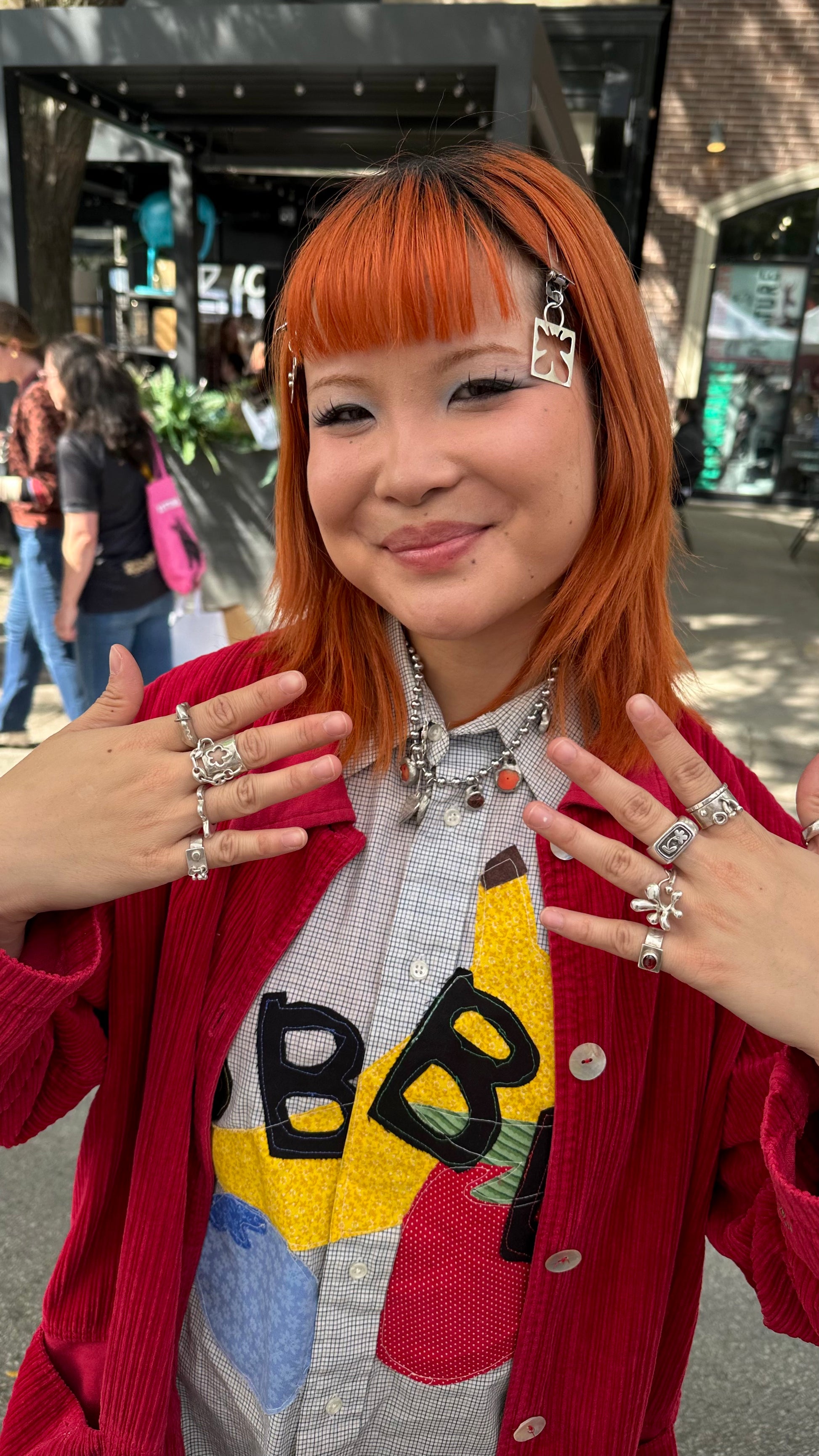 Girl with red hair wearing chained flower ring at Renegade Craft Fair