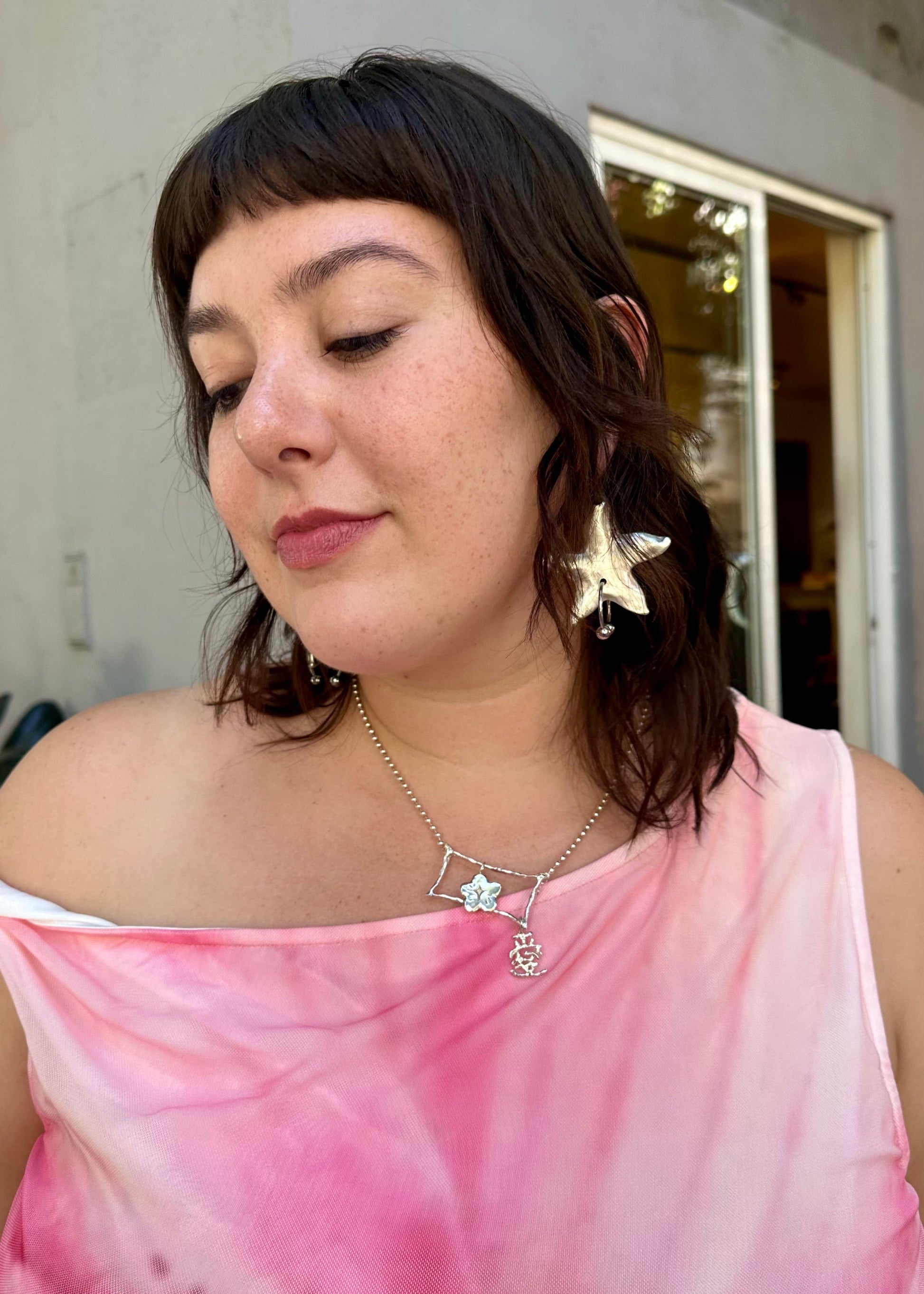 girl wearing 935 silver necklace with extended chain, flower pendant