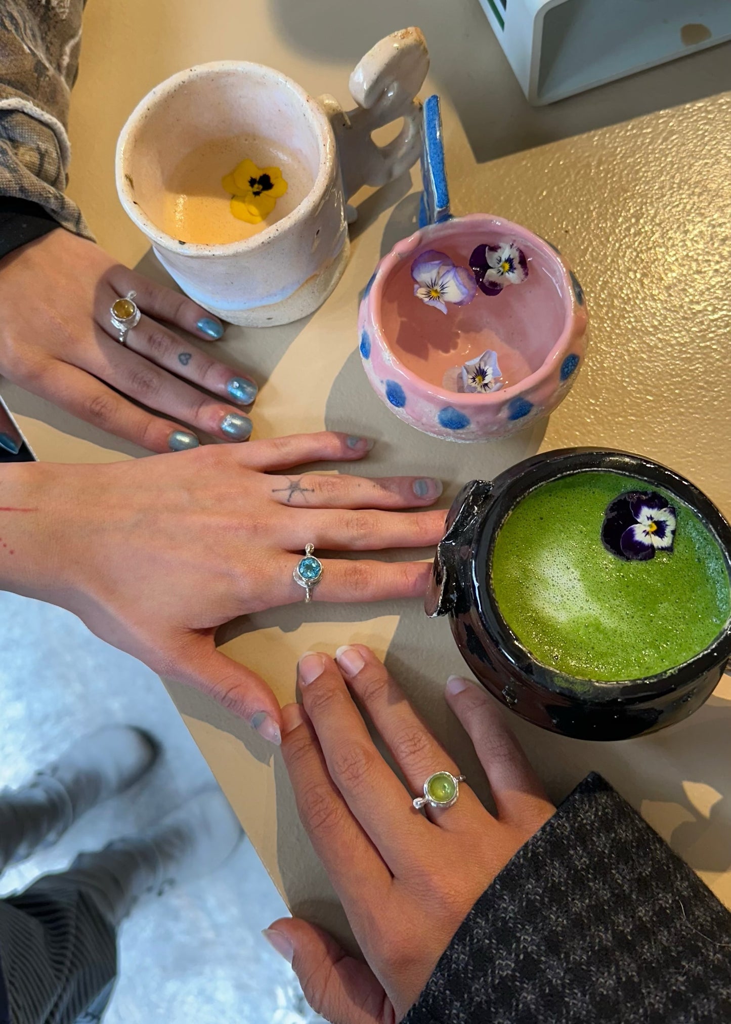 different variations of tea cup rings: peridot, blue topaz, yellow topaz